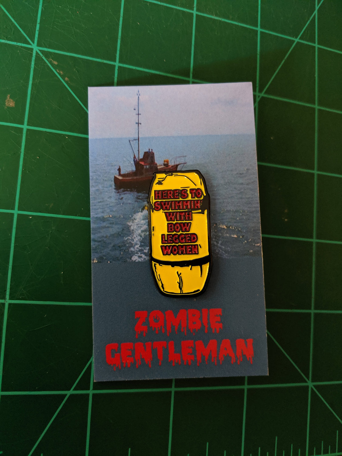Jaws "Here's to swimmin' with bow legged women" enamel pin